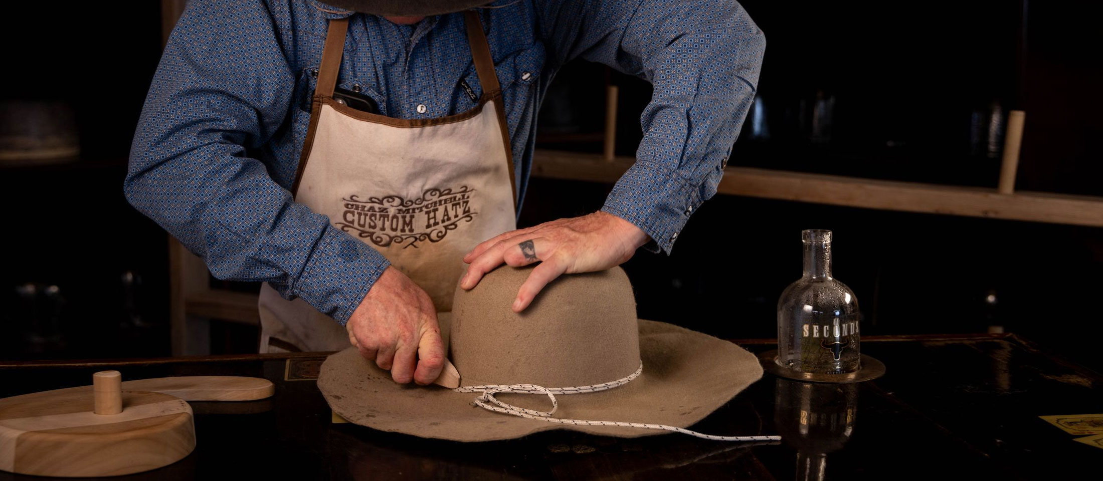 A man working on a hat.
